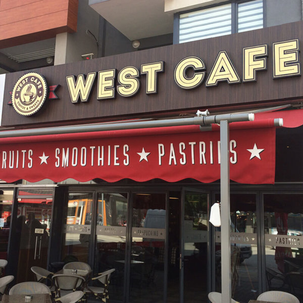 LED channel letters on wooden sign - West Cafe