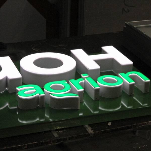 Illuminated channel letters embossed in a composite panel sign Illuminated channel letters embossed in a composite panel sign