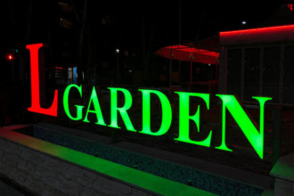 An elegant illuminated lettering at the entrance of Leipzig Garden bar