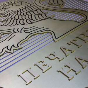 Brass letters Printing Works of BNB installed on a round sign Brass letters Printing Works of BNB installed on a round sign