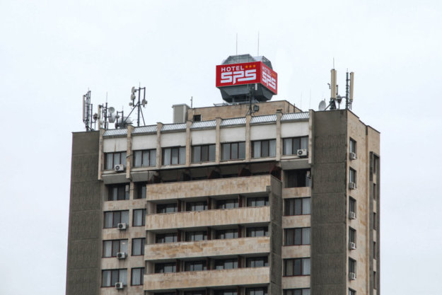 A big illuminated sign on the roof of Hotel SPS
