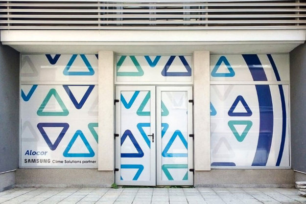 Perforated film installation on glass facade for office