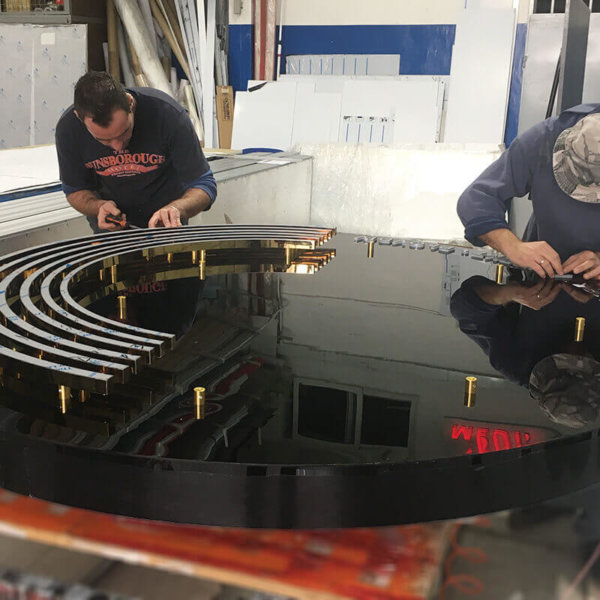 Golden sign with plexiglass and stainless steel - manufacturing process