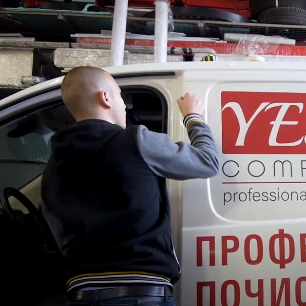 Car wrapping a company bus with self-adhesive graphics.