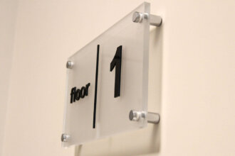 Interior sign with spacers for a hotel