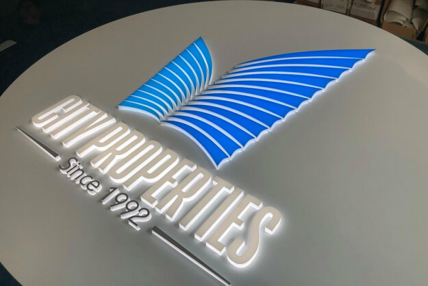 Round illuminated sign for City Properties office in Plovdiv