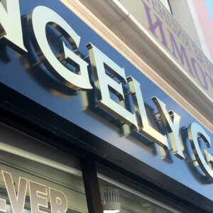 Channel letters with spacers, made of gold inox Channel letters with spacers, made of gold inox