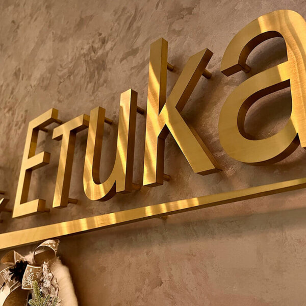 Interior golden stainless steel channel letters and logo for Medical Center Etika
