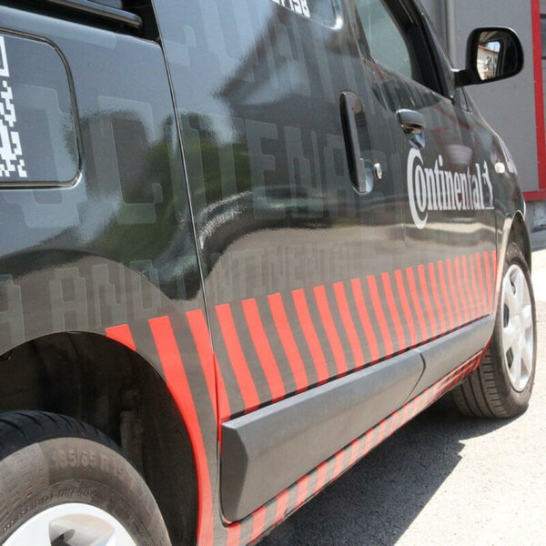 Red stripes made of 3M reflective film on the car doors Red stripes made of 3M reflective film on the car doors