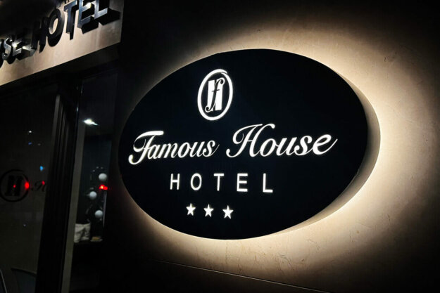 Illuminated sign for Famous House hotel