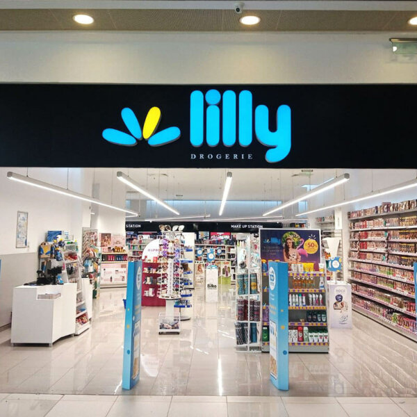 Illuminated channel letters on composite panel sign for branding Lilly Drogerie store Illuminated channel letters on composite panel sign for branding Lilly Drogerie store