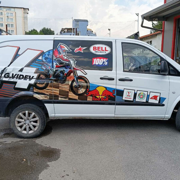 Branding a bus with a printed graphic of a motocross racer