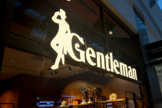 Illuminated channel letters with brass backs and sides for Gentleman store