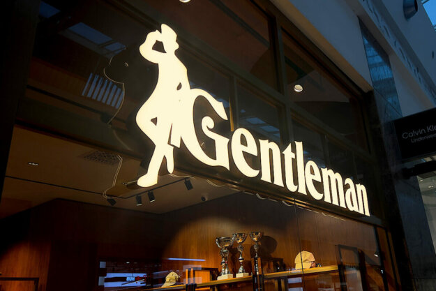 Illuminated channel letters with brass backs and sides for Gentleman store