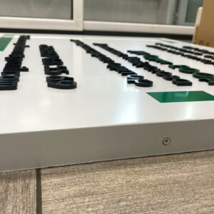 Embossed letters of plexiglass on a bond sign