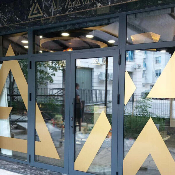 Gold metallic window film for branding Al Amar office
