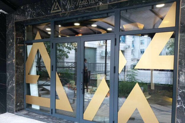 Gold metallic window film for branding Al Amar office