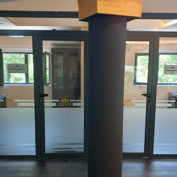 Wrapping showcases at office with frosted film and self-adhesive inscriptions Wrapping showcases at office with frosted film and self-adhesive inscriptions