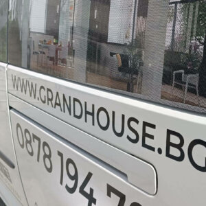 Grand House website and phone number printed on a car Grand House website and phone number printed on a car
